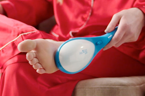 woman scraping foot with pedegg