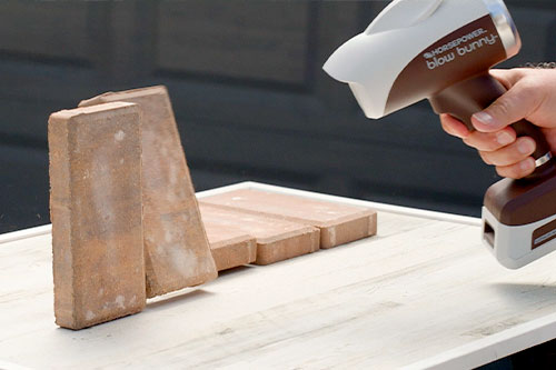 blowing down bricks