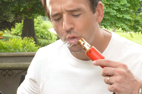 man drinking from pocket hose