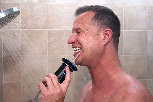 man in shower using flosser saucer