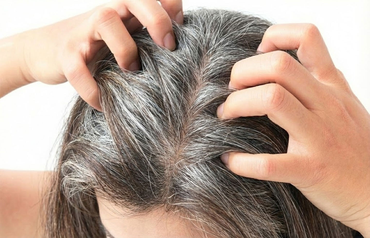 woman grasping her hair