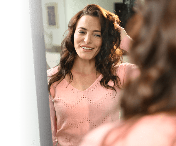 woman looking in mirror