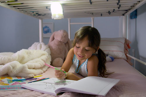 child coloring with light