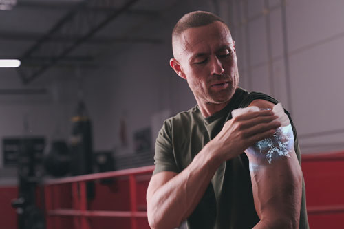 man rubbing shoulder