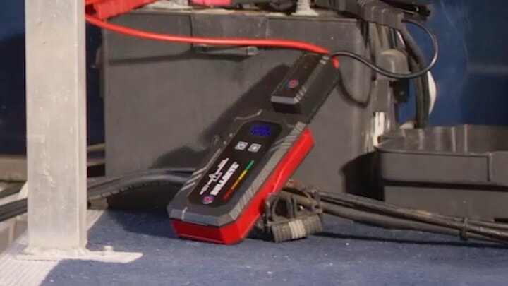 Bullseye Safety XL jump starter clamped to a marine battery on a boat