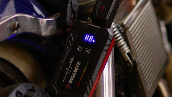 Bullseye Safety XL jump starter connected to a motorcycle battery