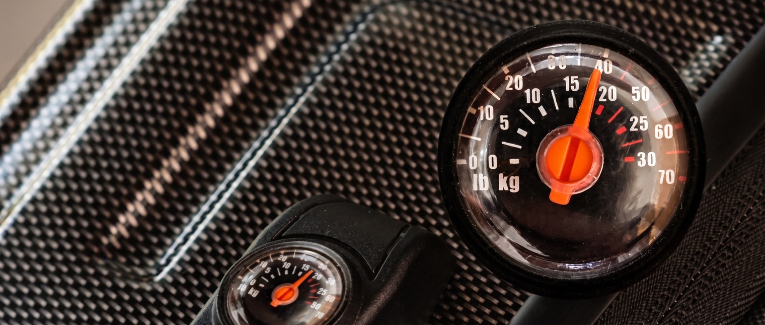 The built-in scale dial on the handle of the Bell and Howell case, with the weight reading visible