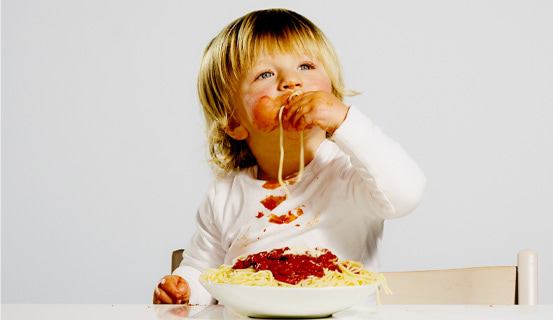 Toddler eating spaghetti