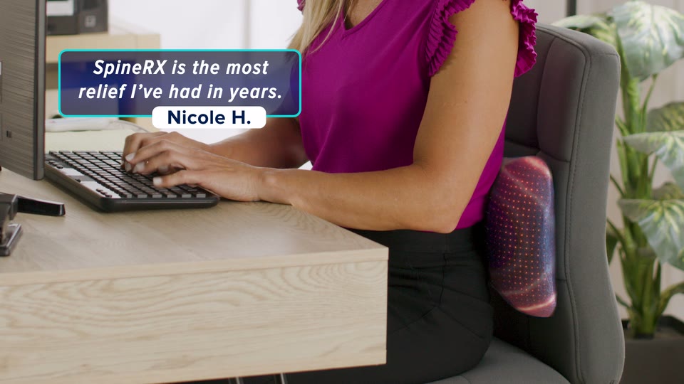Nicole H. at her desk with SpineRX behind her back