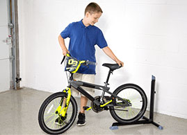 Boy backing his bike into the Bike Nook