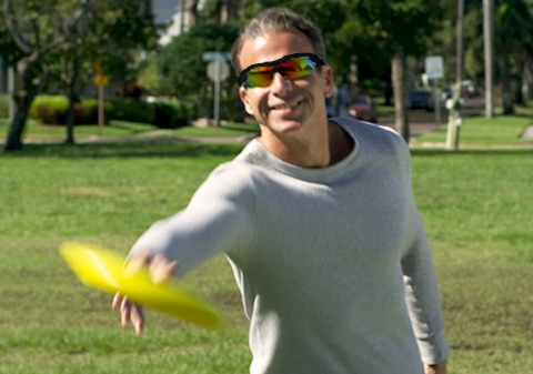 Man wearing Battle Vision in park catching frisbee