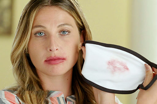 Woman Putting On Face Mask